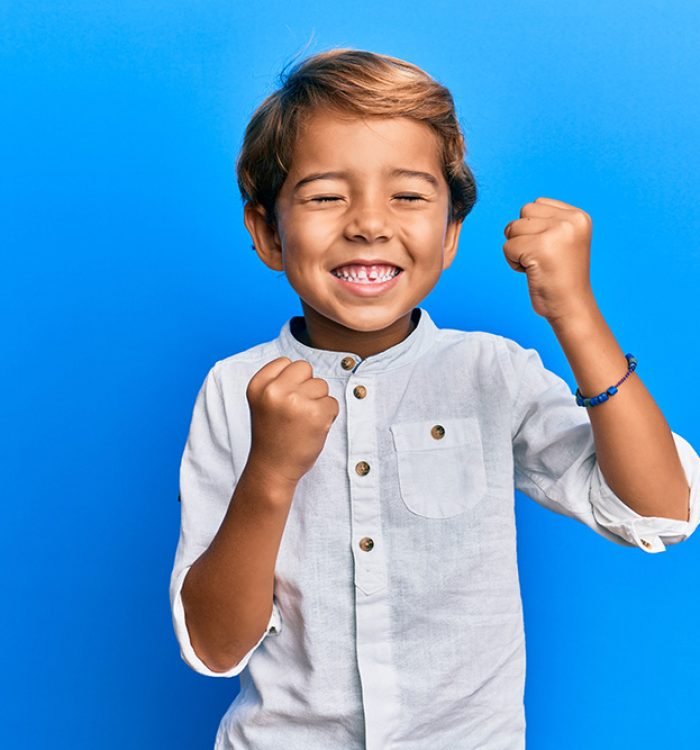 Adorable latin kid wearing casual clothes celebrating surprised and amazed for success with arms raised and eyes closed